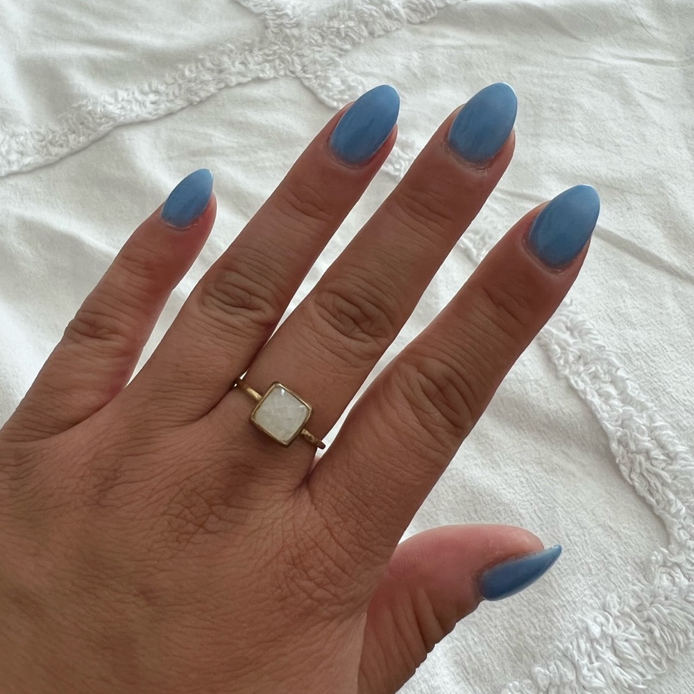 Gold ring with white stone